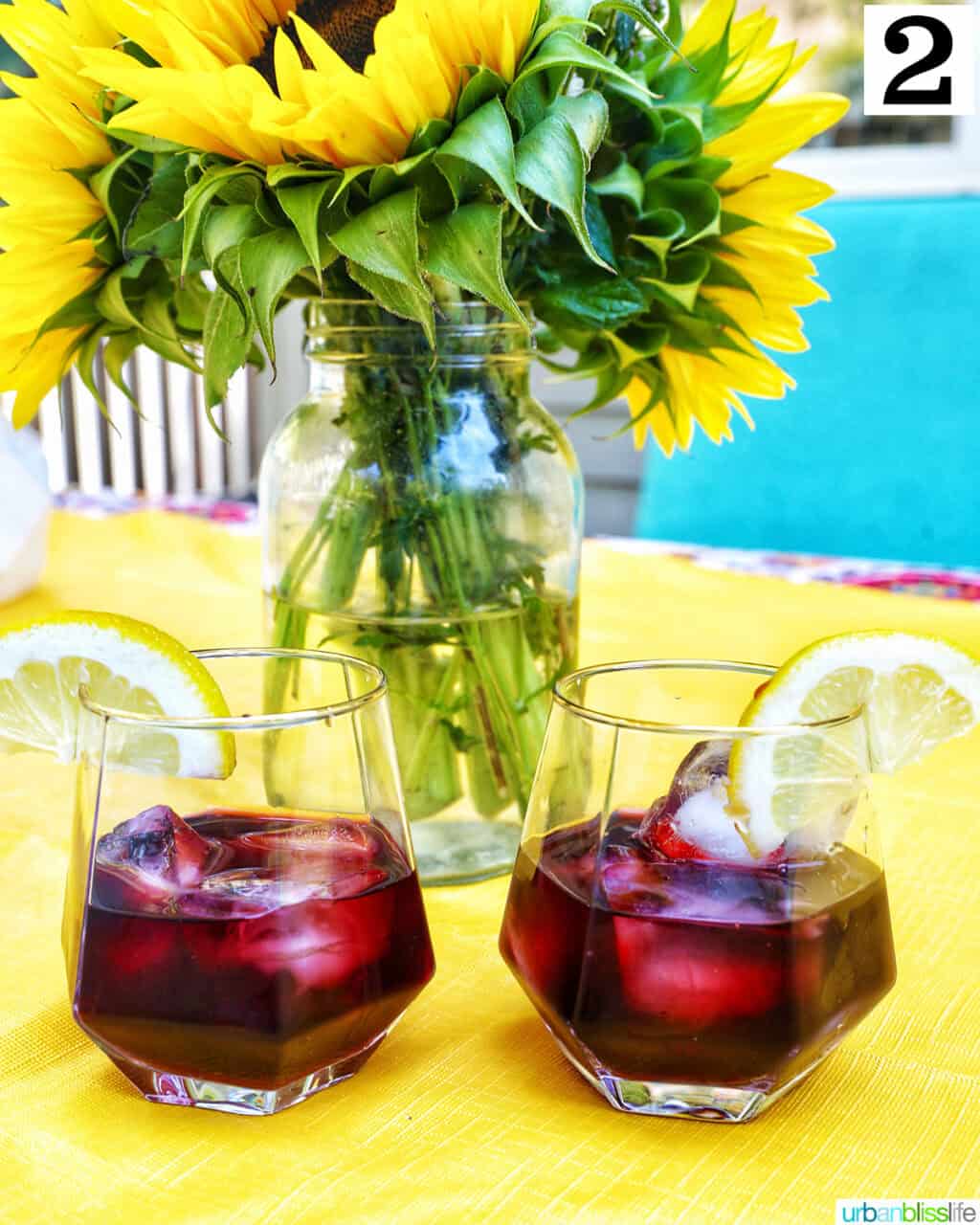 two glasses of red wine over ice.