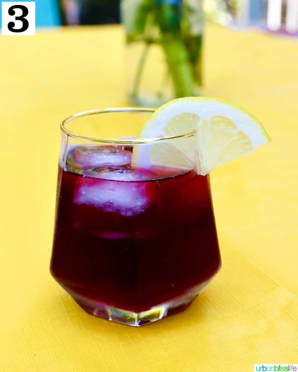 glass of tinto de verano wine cocktail with lemon slice.