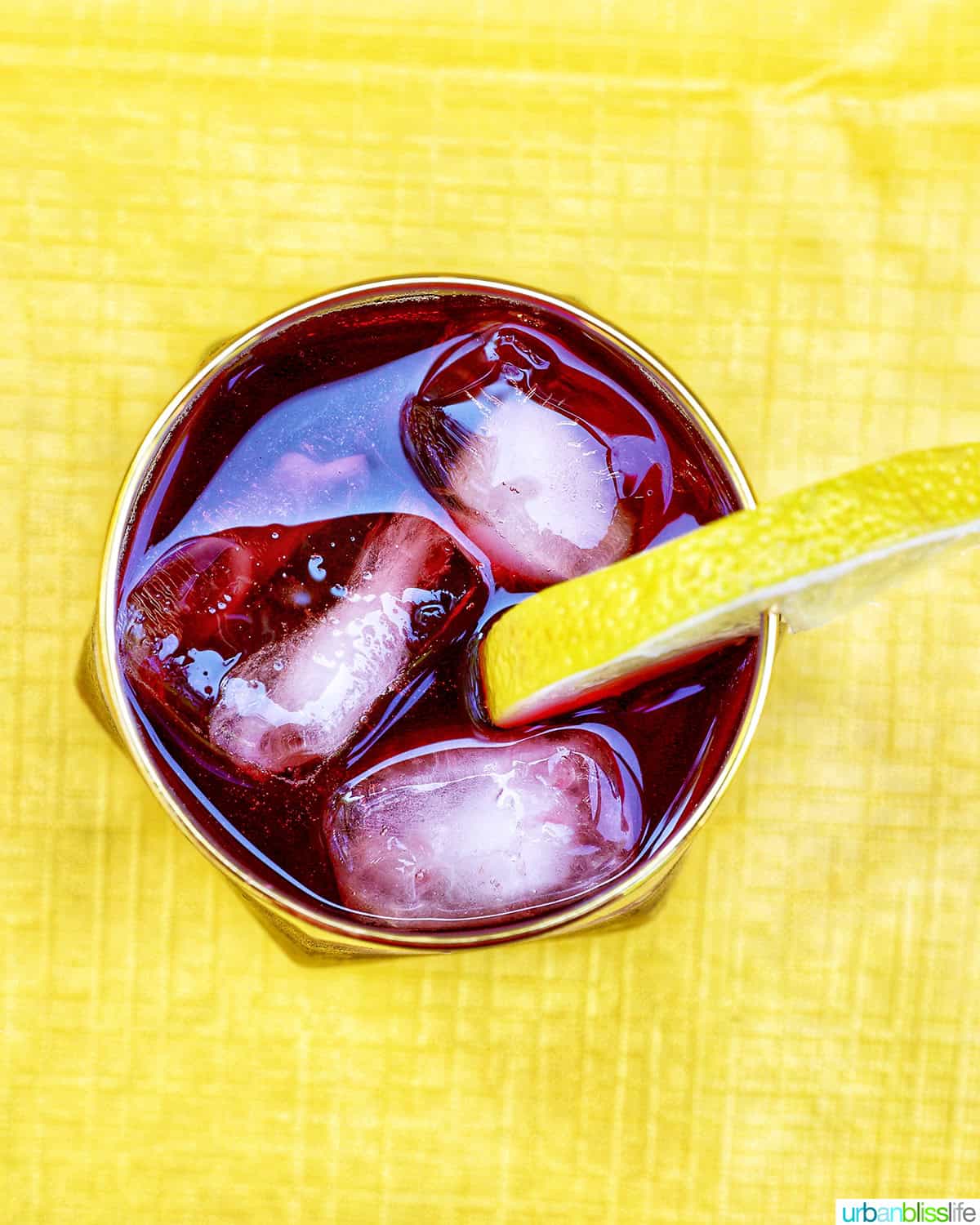 overhead of glass of tinto de verano wine cocktail with lemon slice.