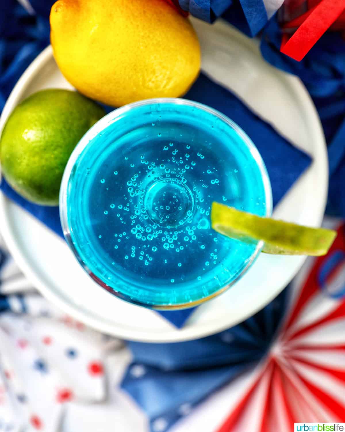 overhead of blue wave cocktail with lime and lemon.