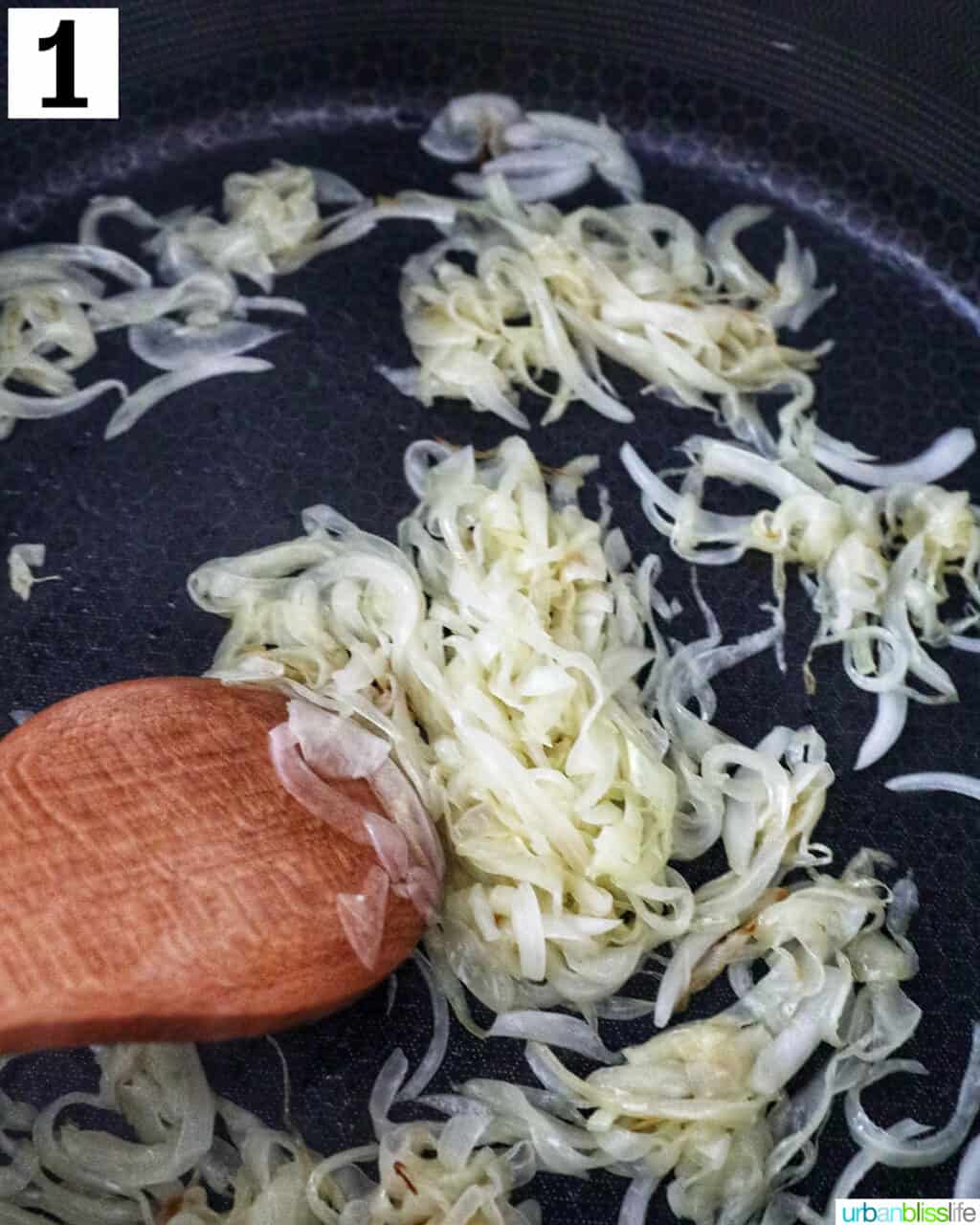 onions in a skillet with wooden skillet.