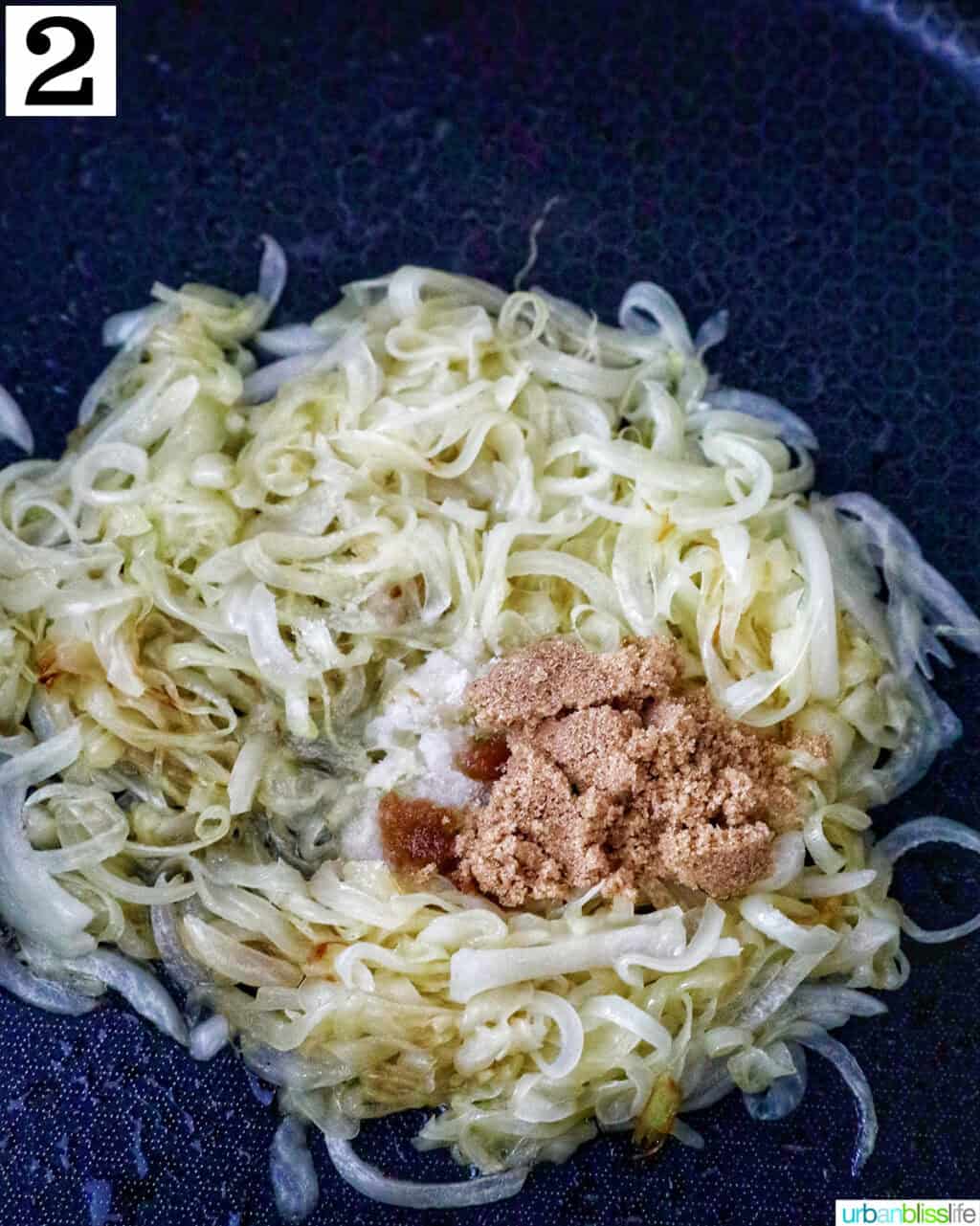 sliced onions with brown sugar in a skillet.