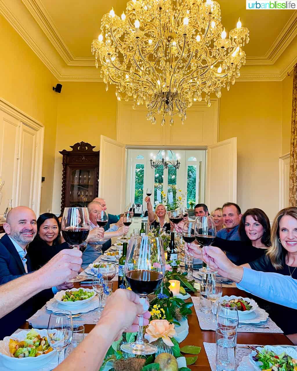 cheers at dinner table at Chateau de Valcreuse in La Roche-Posay, France.