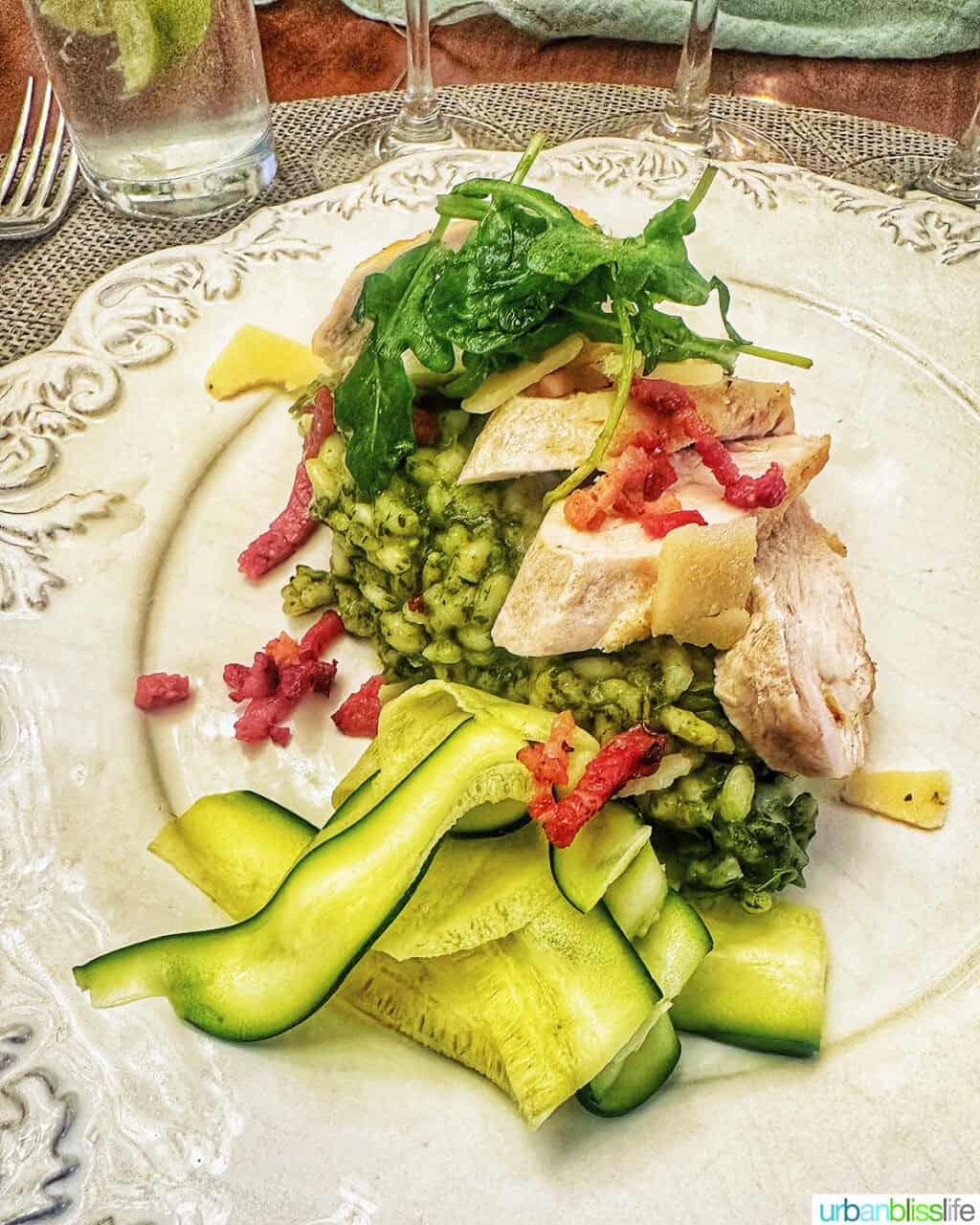 chicken zucchini pesto risotto on a plate at Chateau de Valcreuse.
