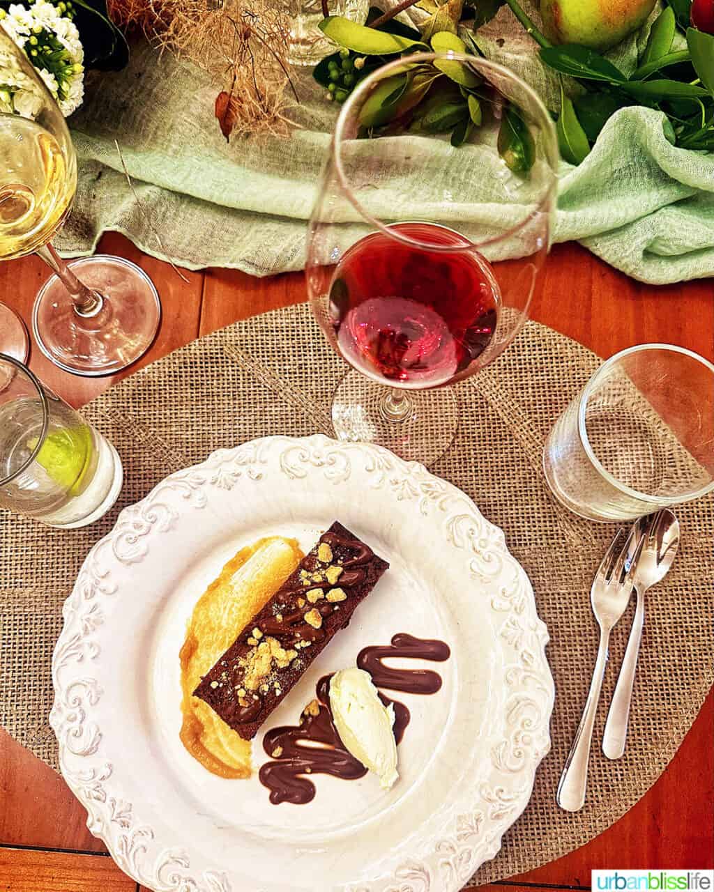 dessert on a plate with glass of wine and beautiful table setting at Chateau de Valcreuse.