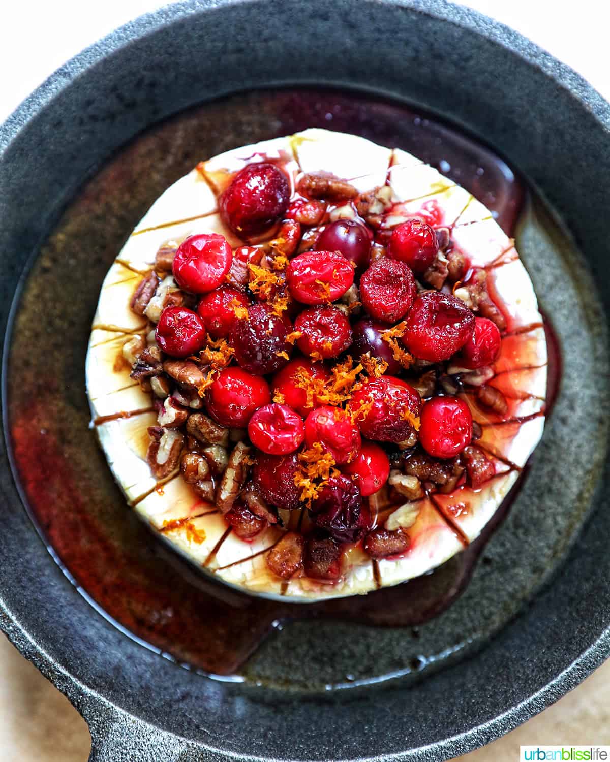 cranberry pecan baked brie in a skillet.