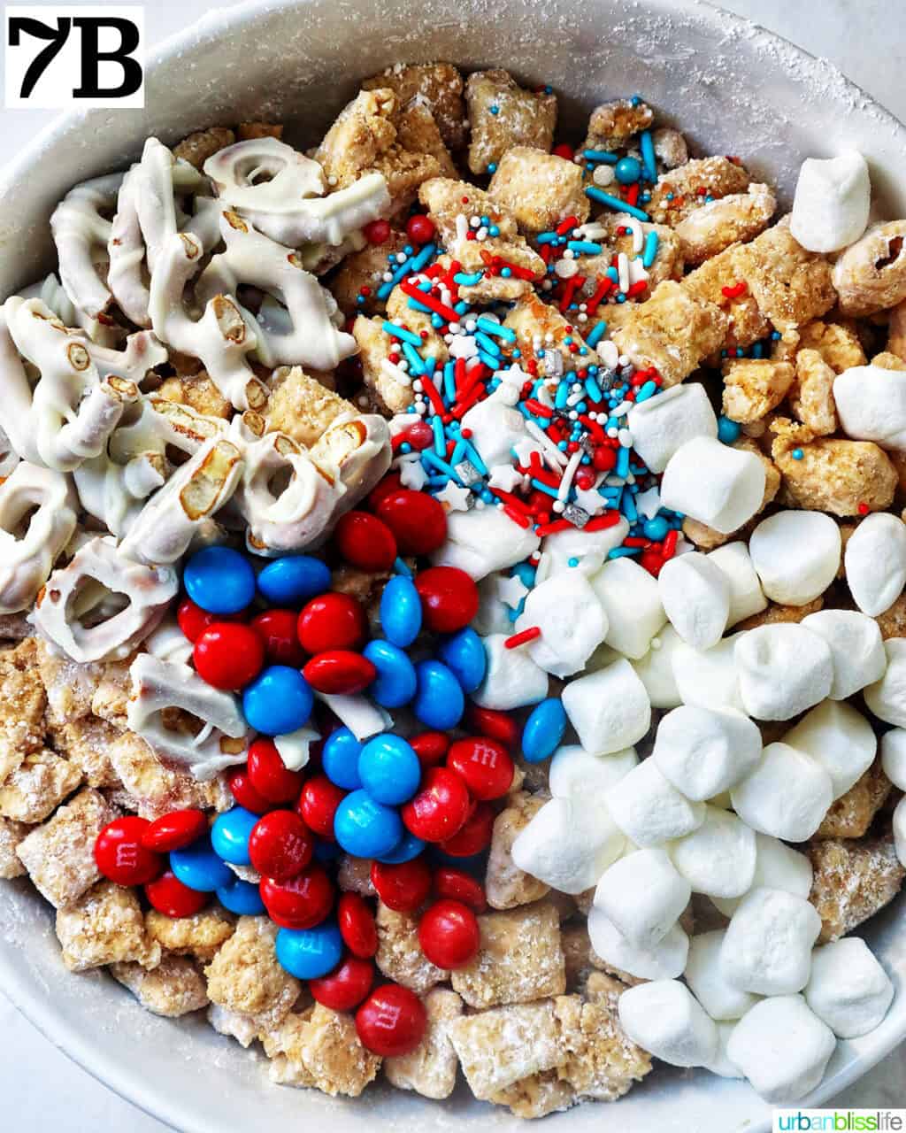 large bowl with marshmallows, red and blue M & M candies, pretzels, rice chex mix to make patriotic puppy chow.