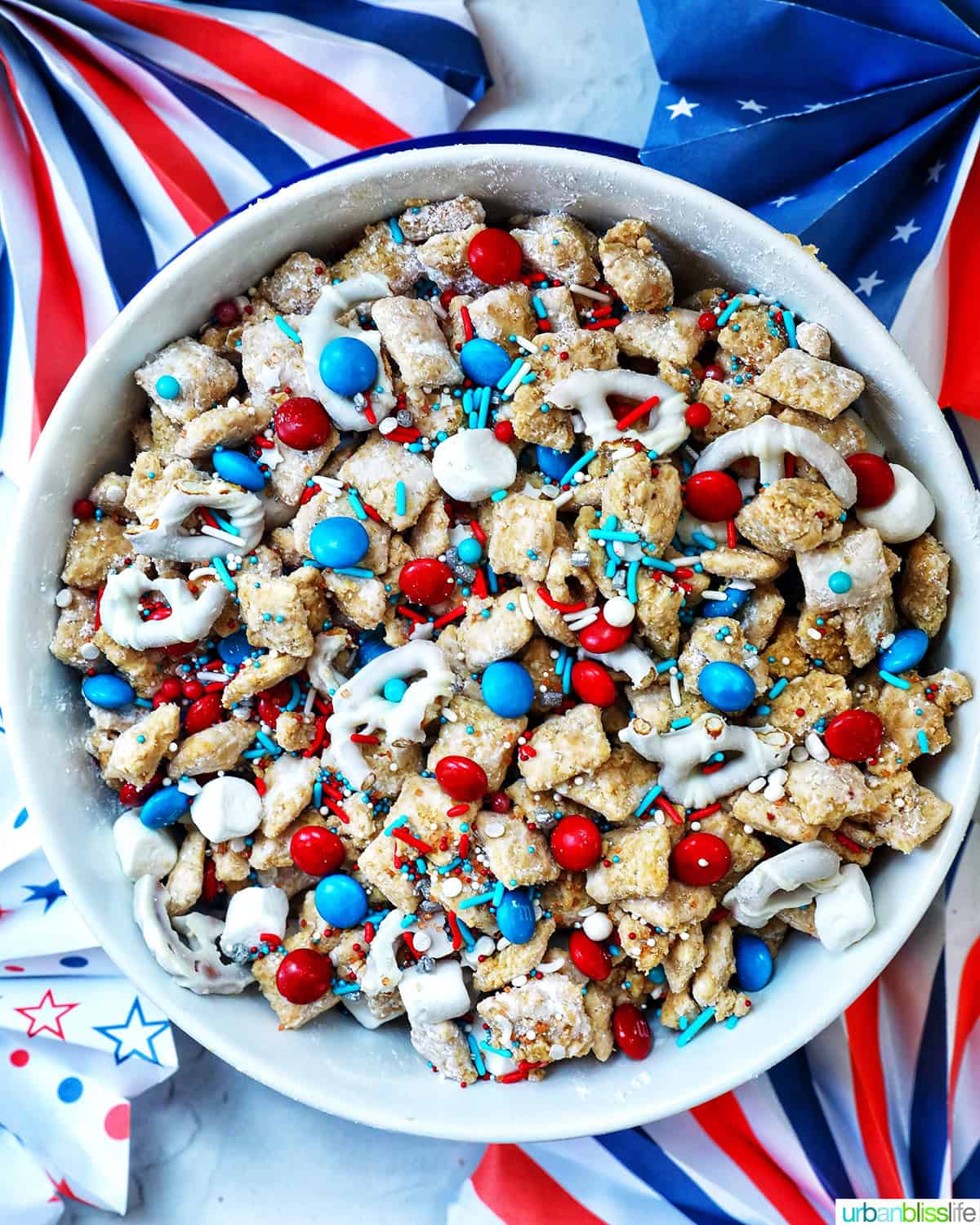 large bowl of patriotic puppy chow and red, white, and blue decorations.