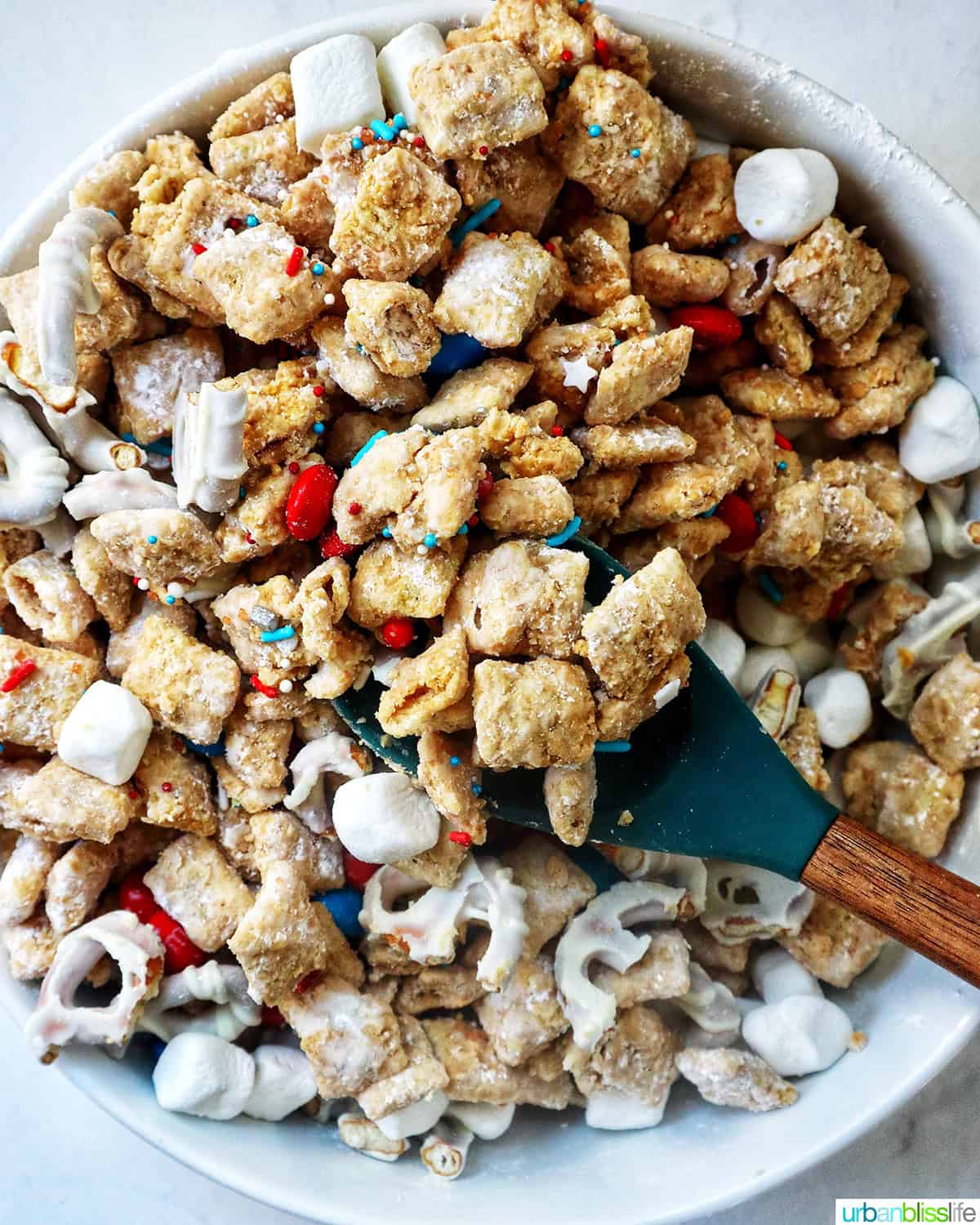 patriotic puppy chow with a serving spoon in a large bowl.