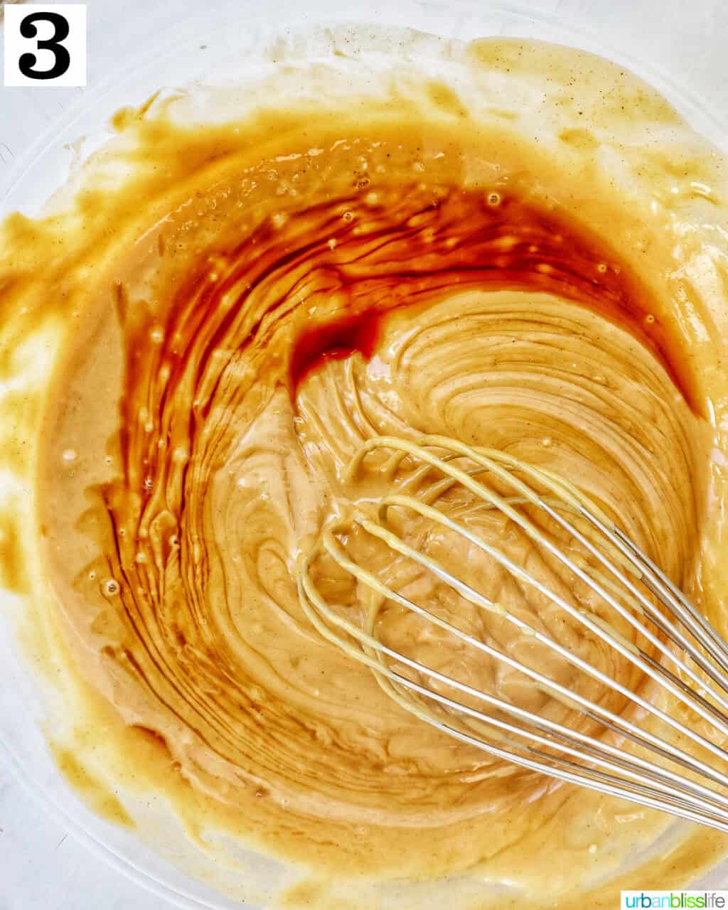 whisking puppy chow peanut butter mixture in a large bowl.