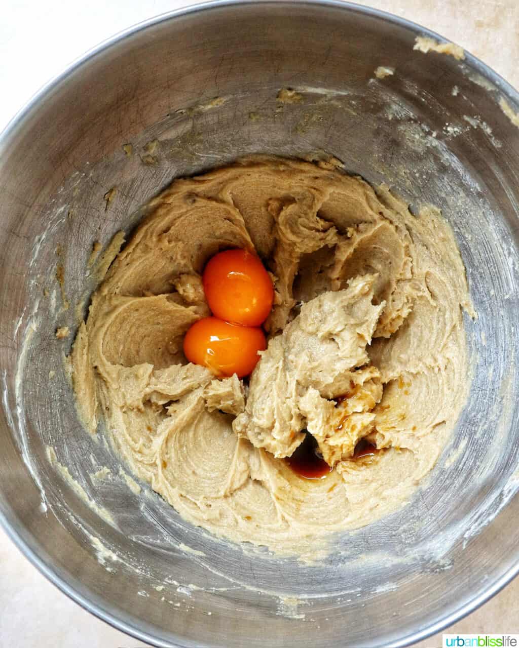 pumpkin pie spice batter in a stand mixer bowl.