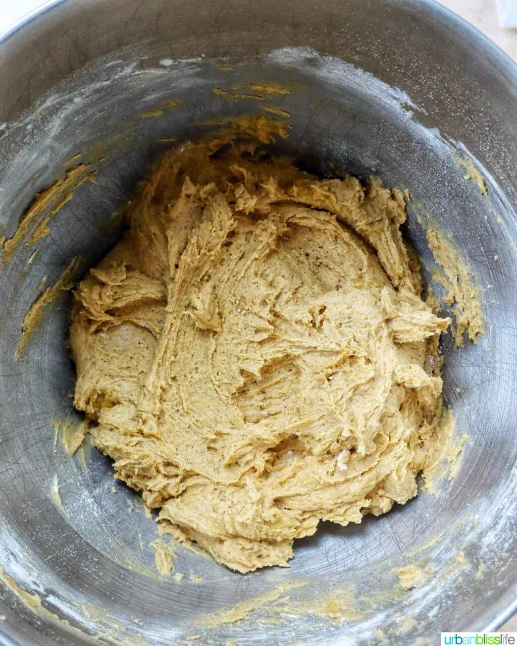 pumpkin pie spice batter in a stand mixer bowl.