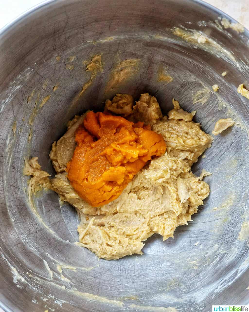 pumpkin pie spice batter in a stand mixer bowl.