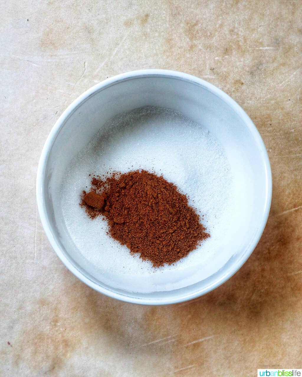 ground cinnamon and granulated sugar in a white bowl.