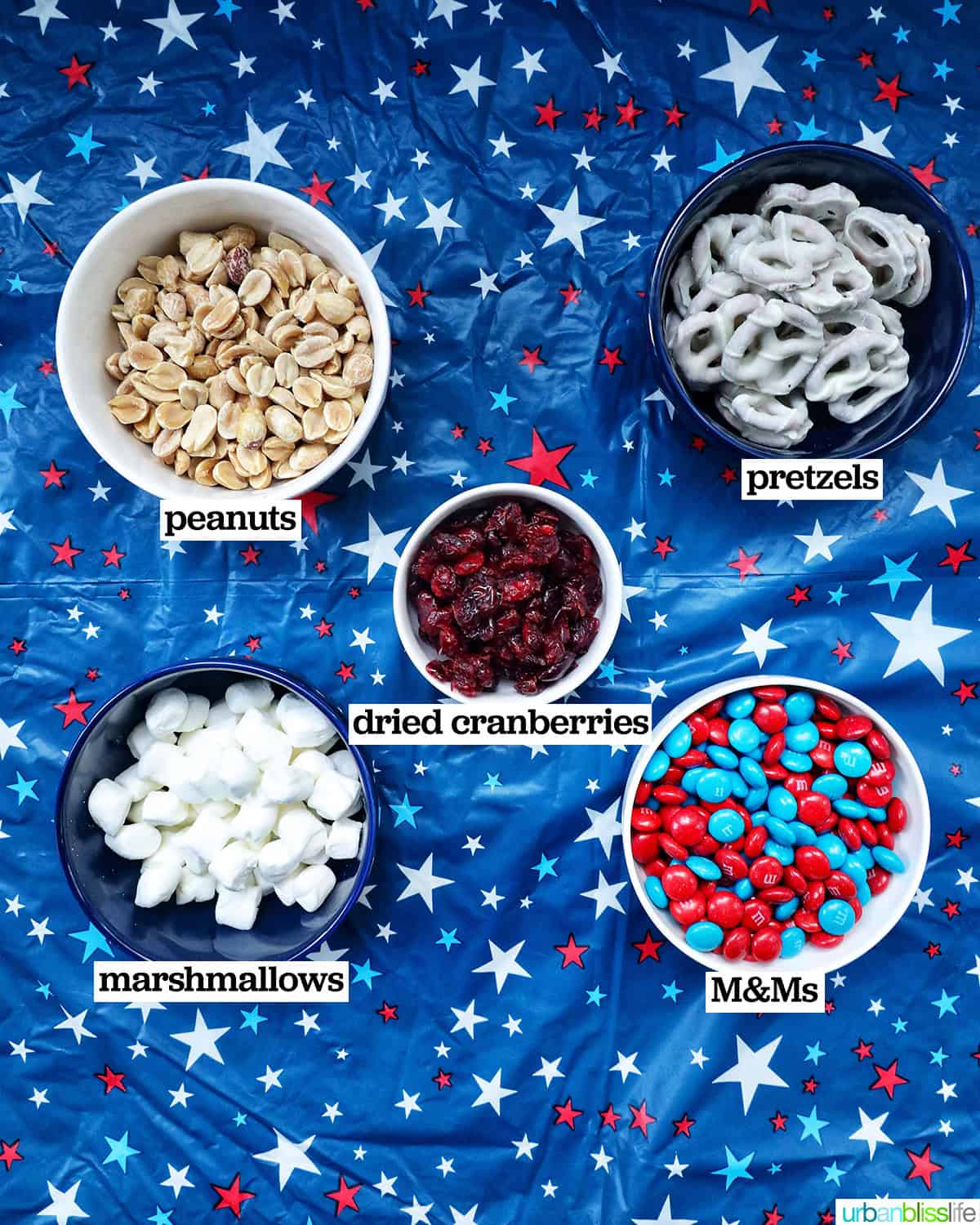 bowls of ingredients to make red, white, and blue trail mix.