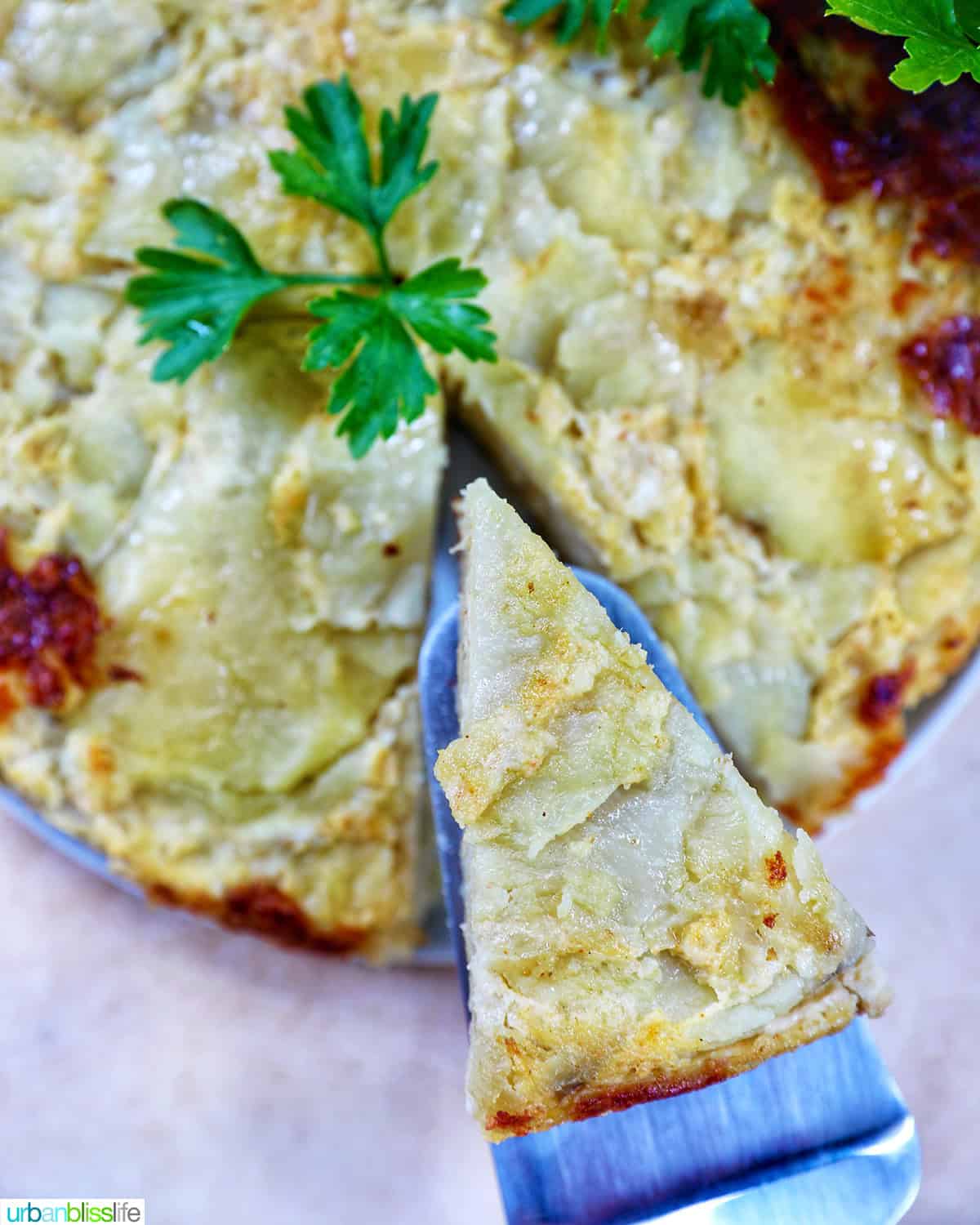 spanish omelette (tortilla de patatas) with a slice cut out.