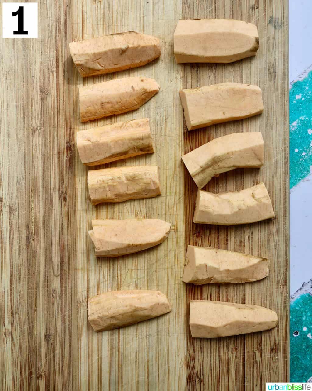 plantains cut in half on a cutting board.