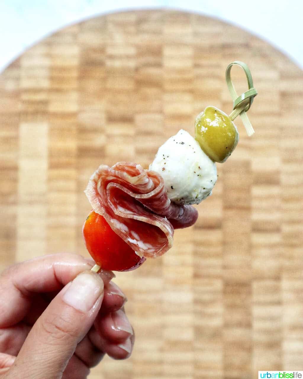 holding an antipasto skewer.