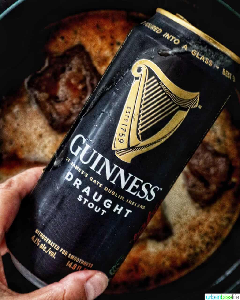 can of Guinness beer over beef short ribs in a Dutch oven.