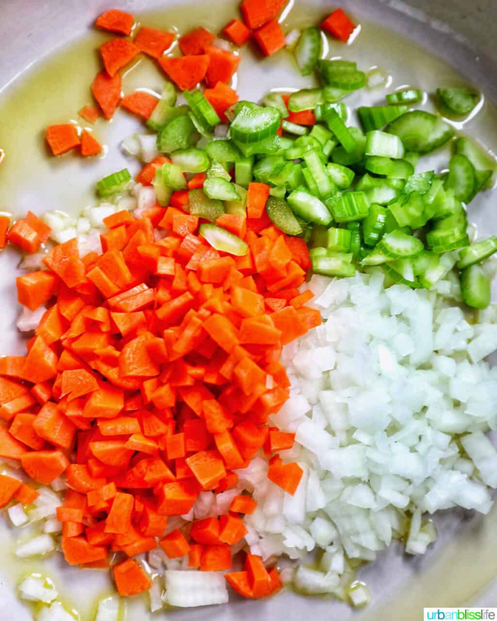 carrots, onions, and celery in a pan.