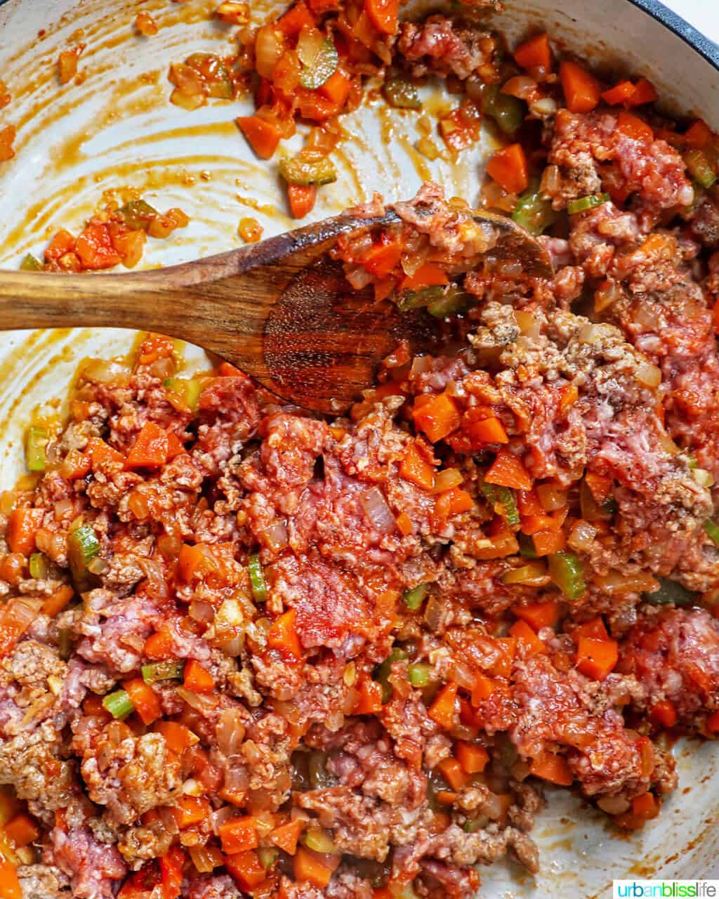 cooking ground lamb and vegetables.