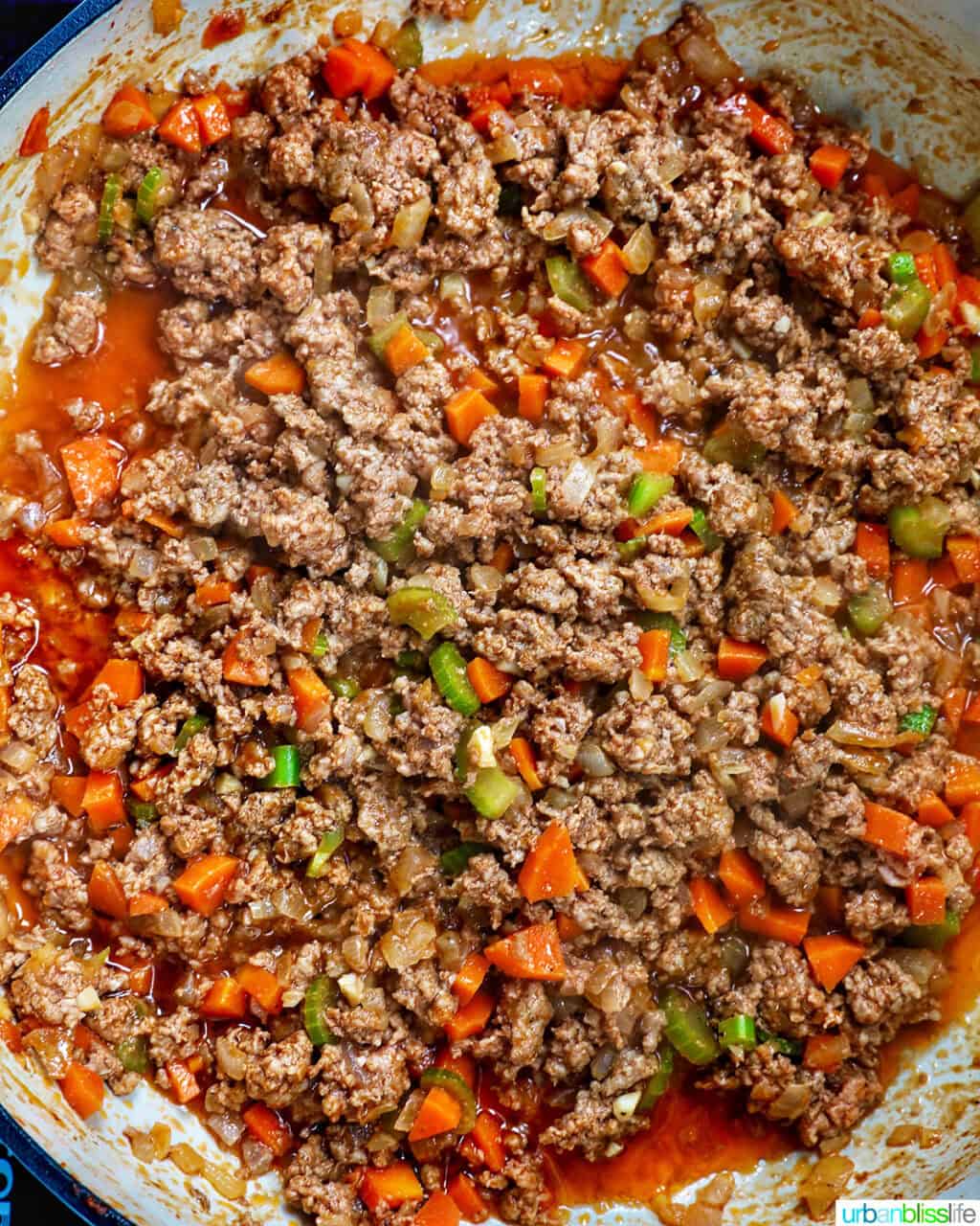 cooked ground lamb with vegetables in a pan.
