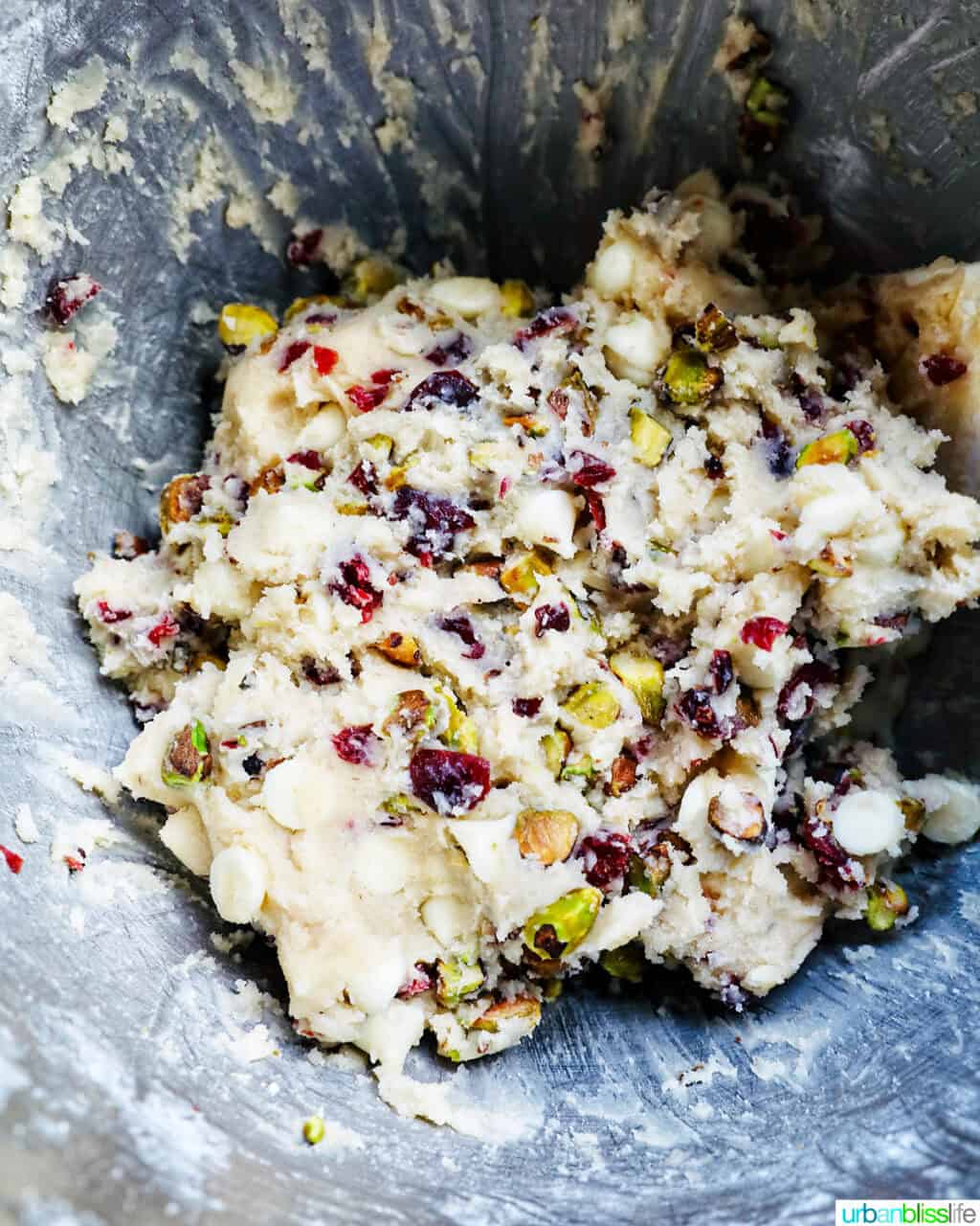 pistachio cranberry shortbread cookie dough in a stand mixer bowl.