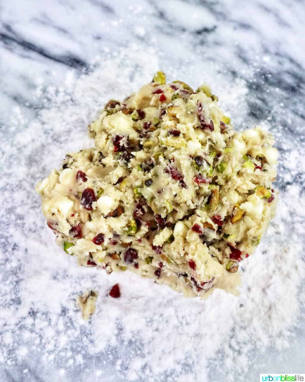 pistachio cranberry shortbread cookie dough on a floured surface.