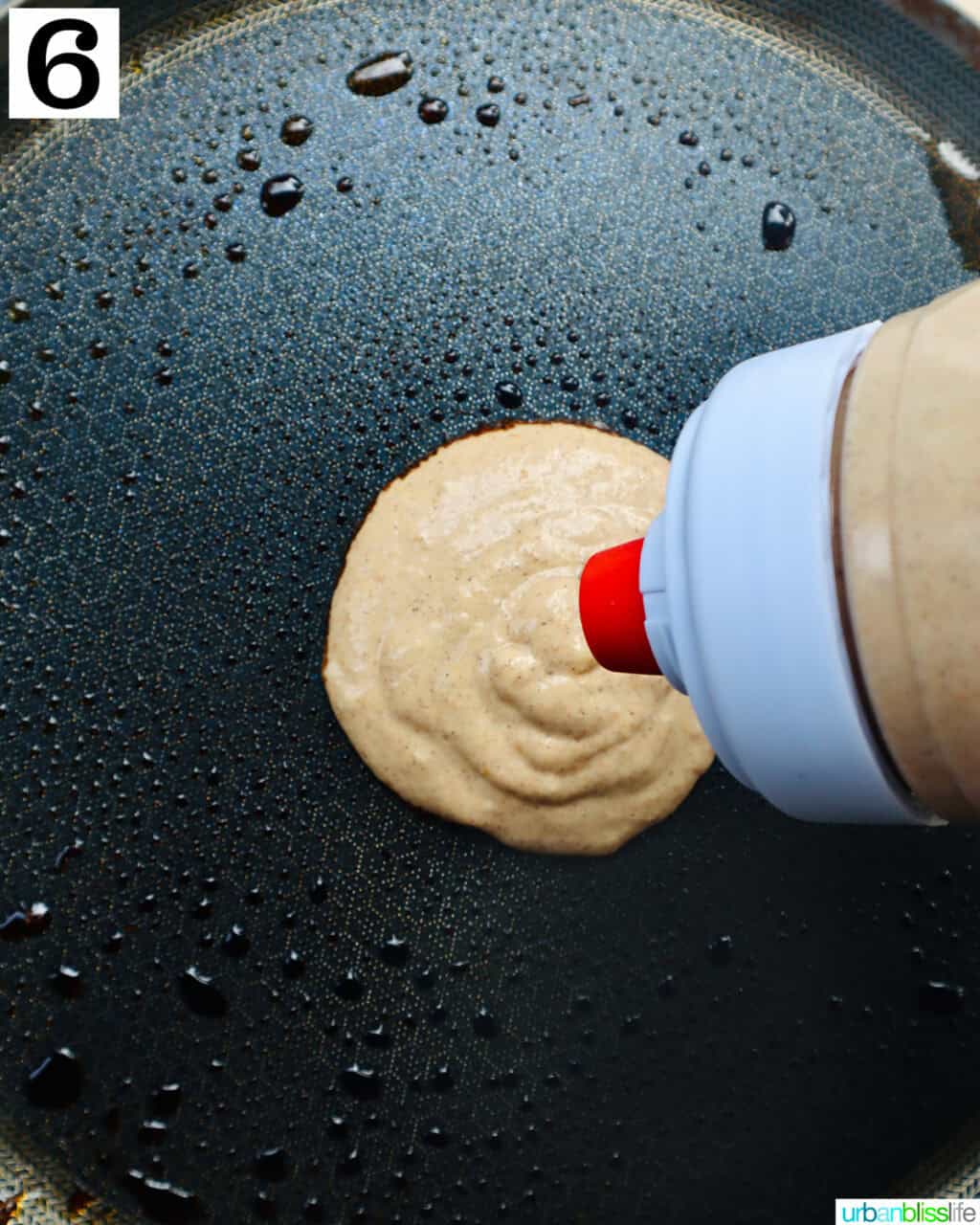 pancake batter being poured onto a hot griddle pan.
