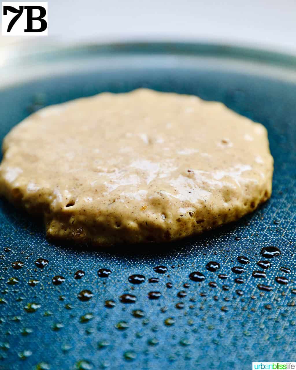 pumpkin spice pancake cooking on a griddle pan.