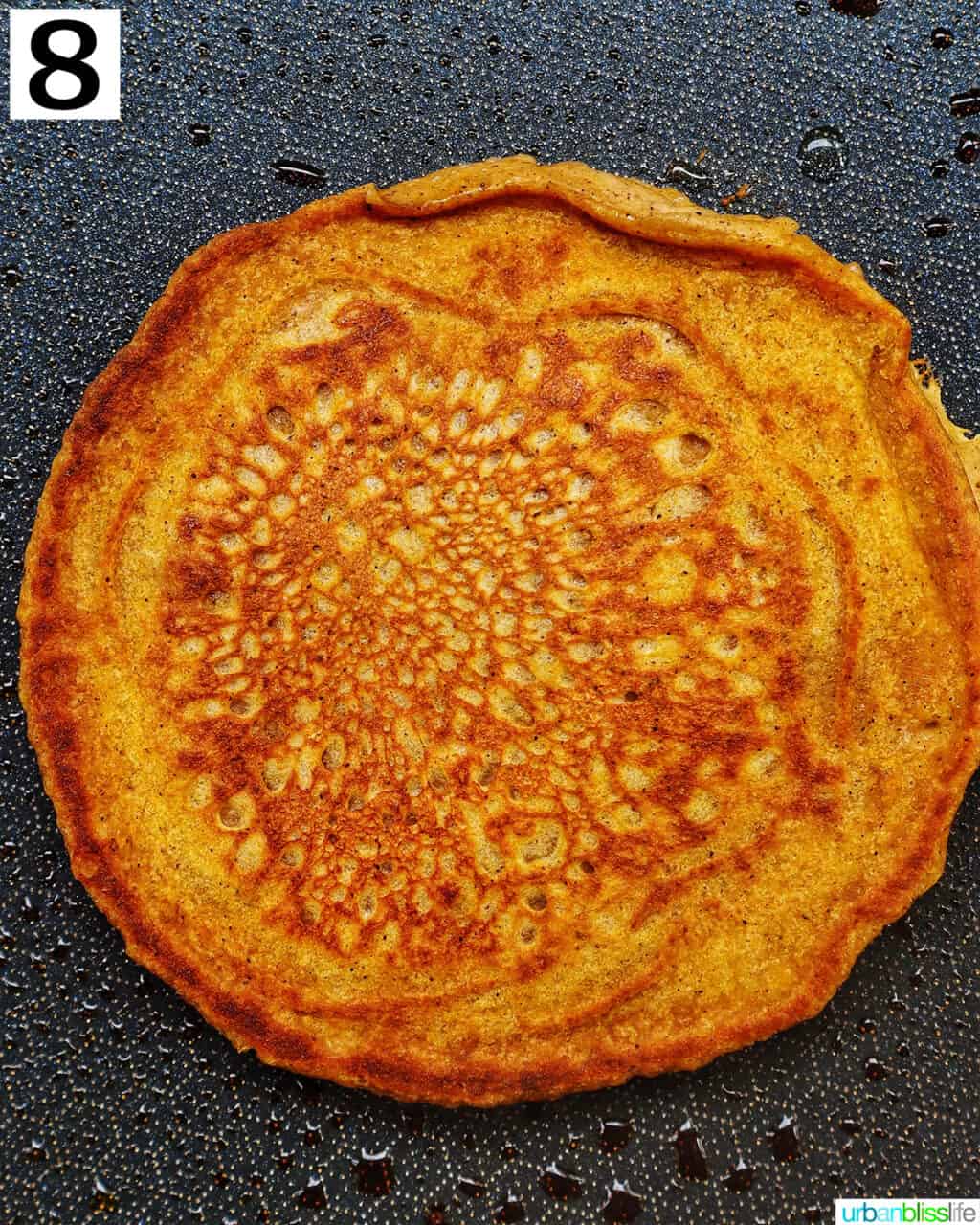 cooked pumpkin spice pancake on a griddle pan.