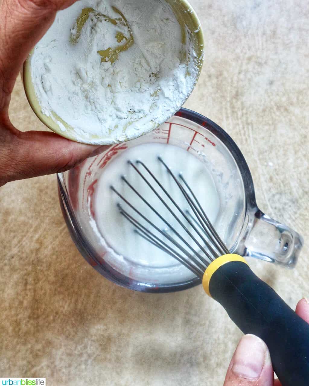 whisking in cornstarch to a cup of water to make a cornstarch slurry.