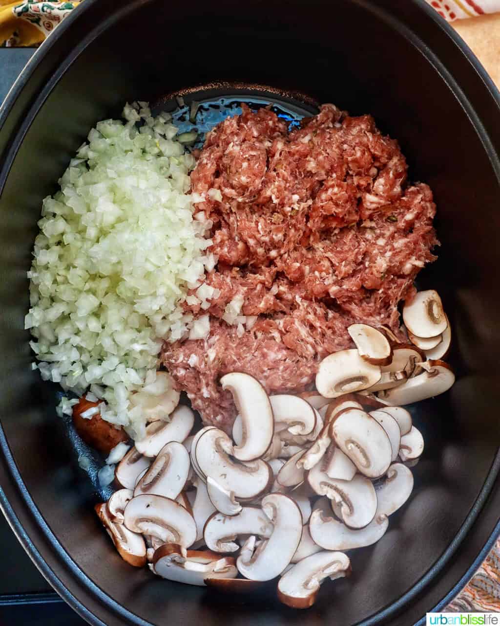onions, mushrooms, and sausage in a dutch oven.