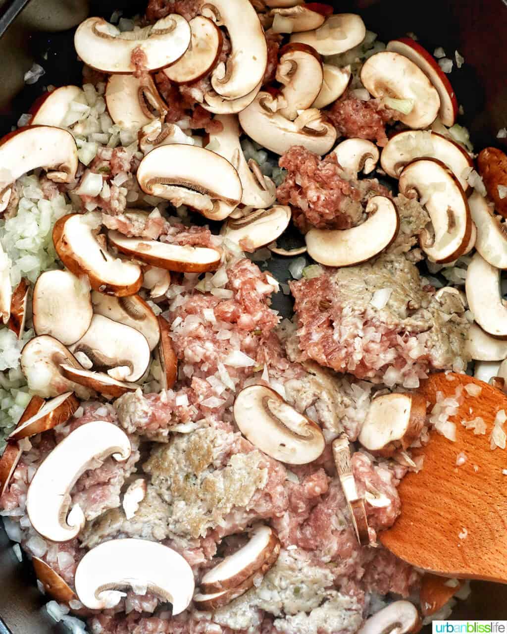 mushrooms and sausage in a dutch oven.