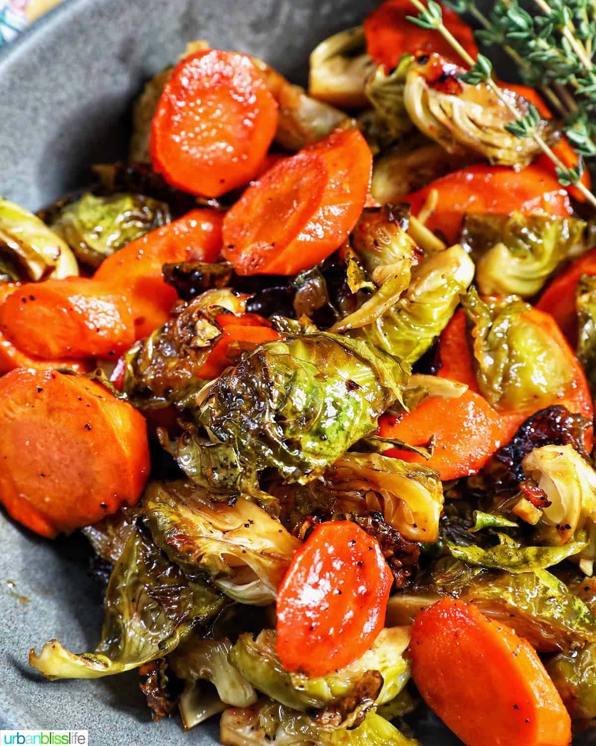 roasted brussels sprouts and carrot slices in a bowl.