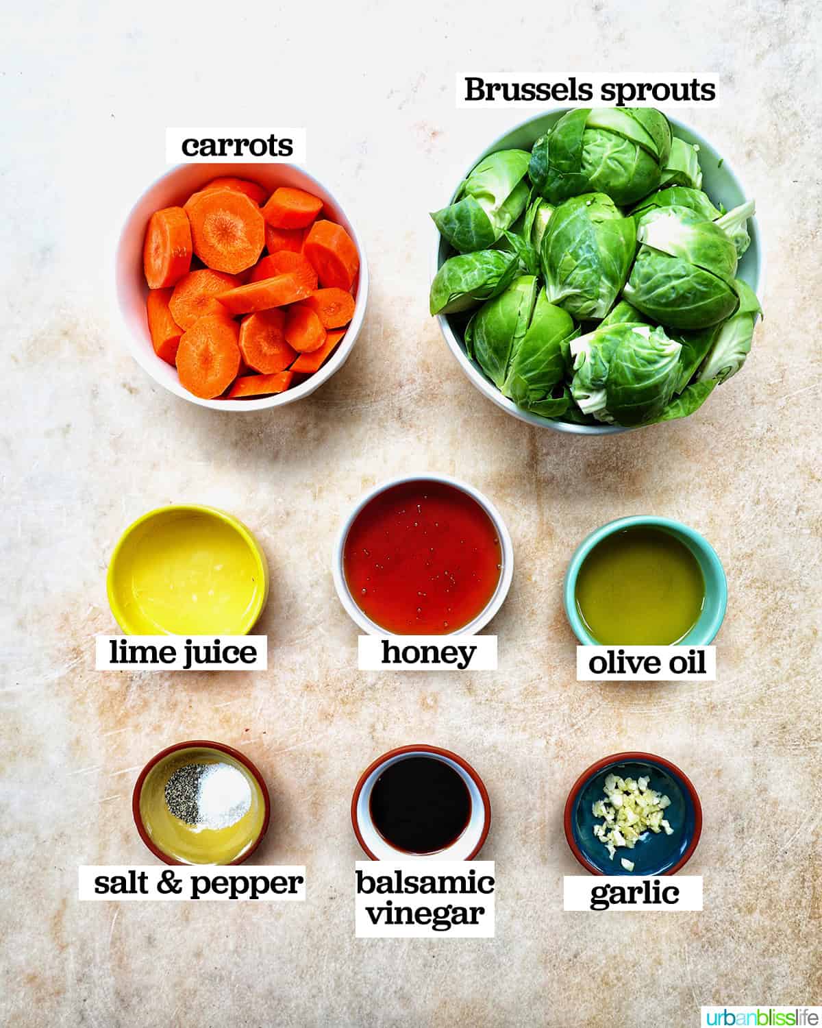 bowls of ingredients to make roasted brussels sprouts and carrots.