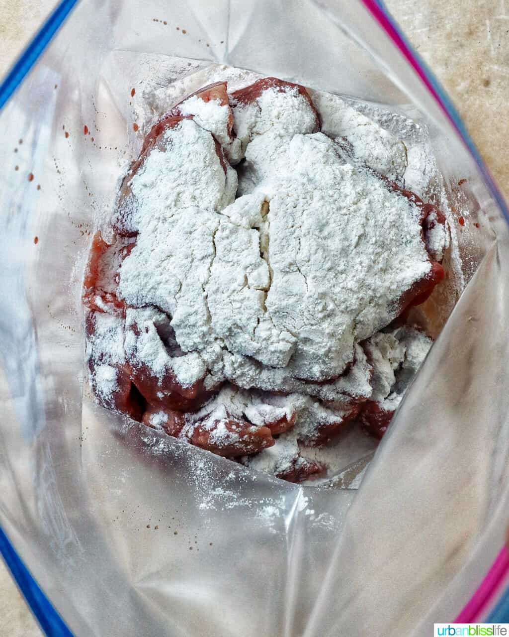 beef and flour in a ziploc bag.