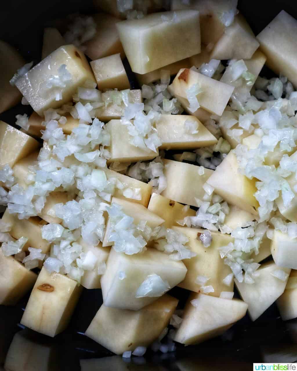 potatoes and onions in a slow cooker.