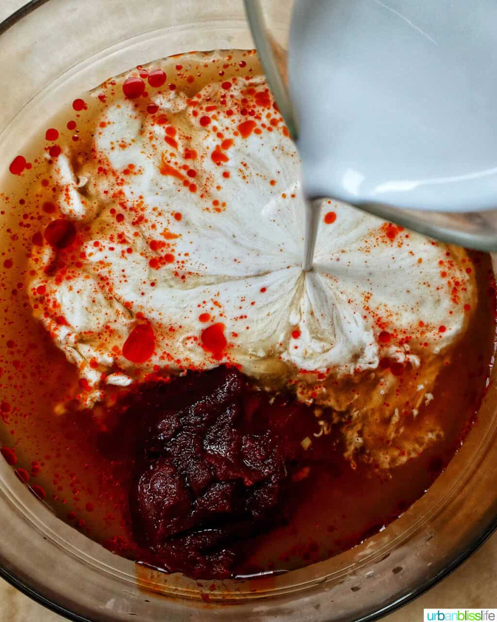 adding cream to curry sauce.