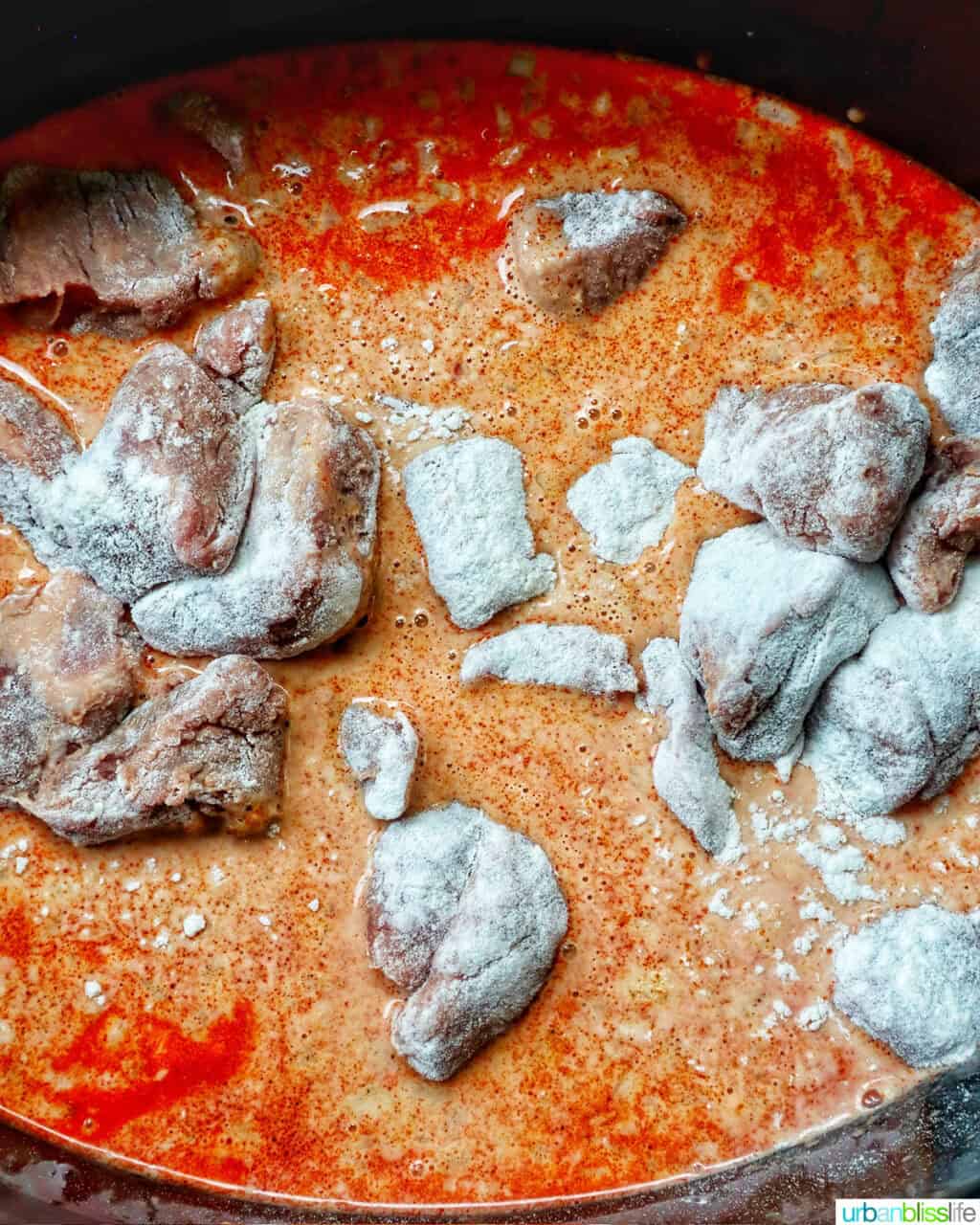 slow cooker beef massaman curry cooking in a crockpot slow cooker.