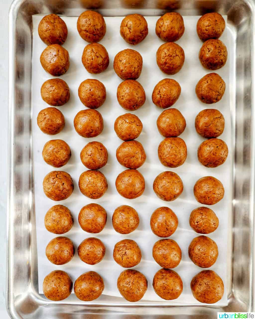 rows of little Biscoff truffles on a baking pan.