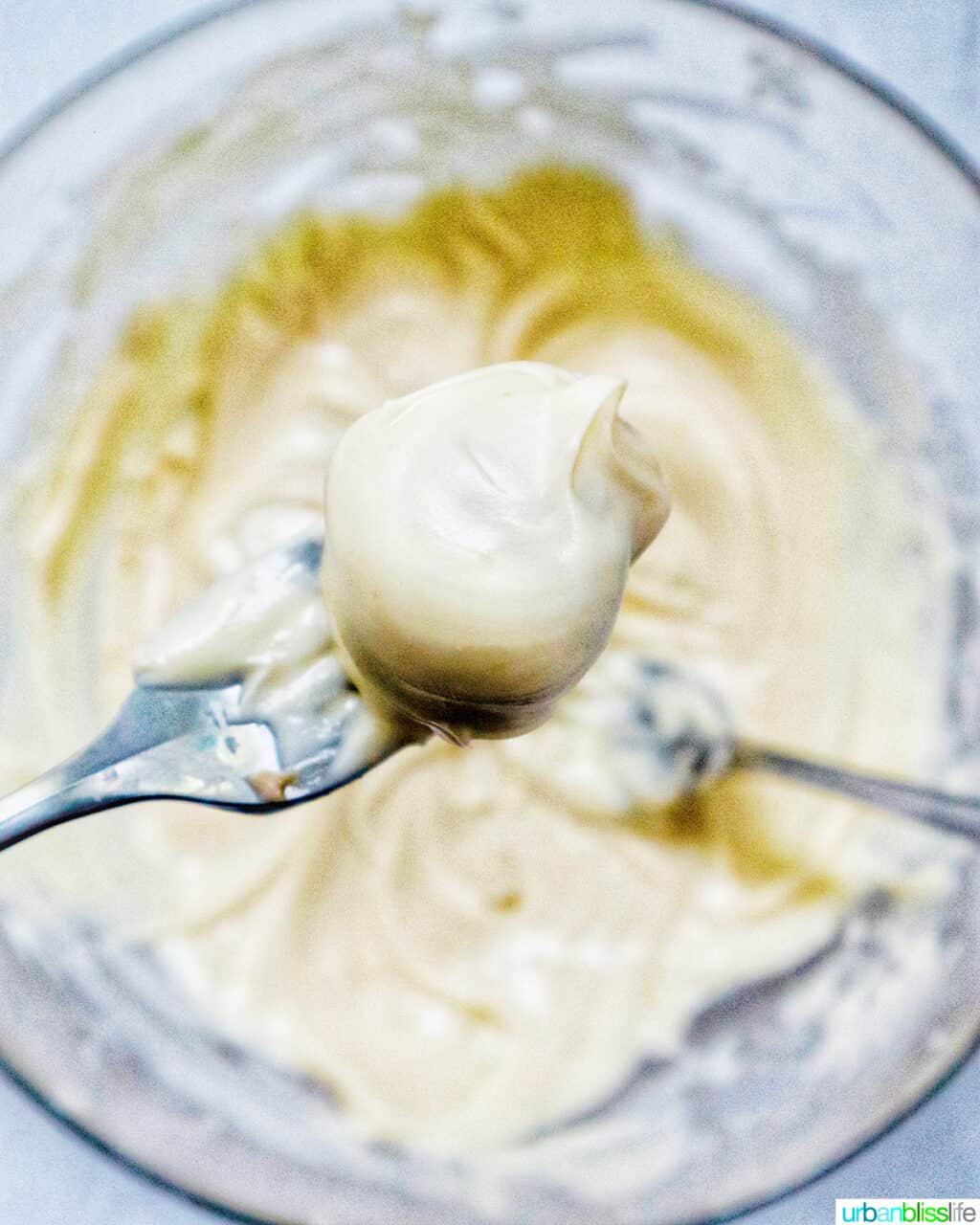 truffle dipped into white chocolate with two forks.