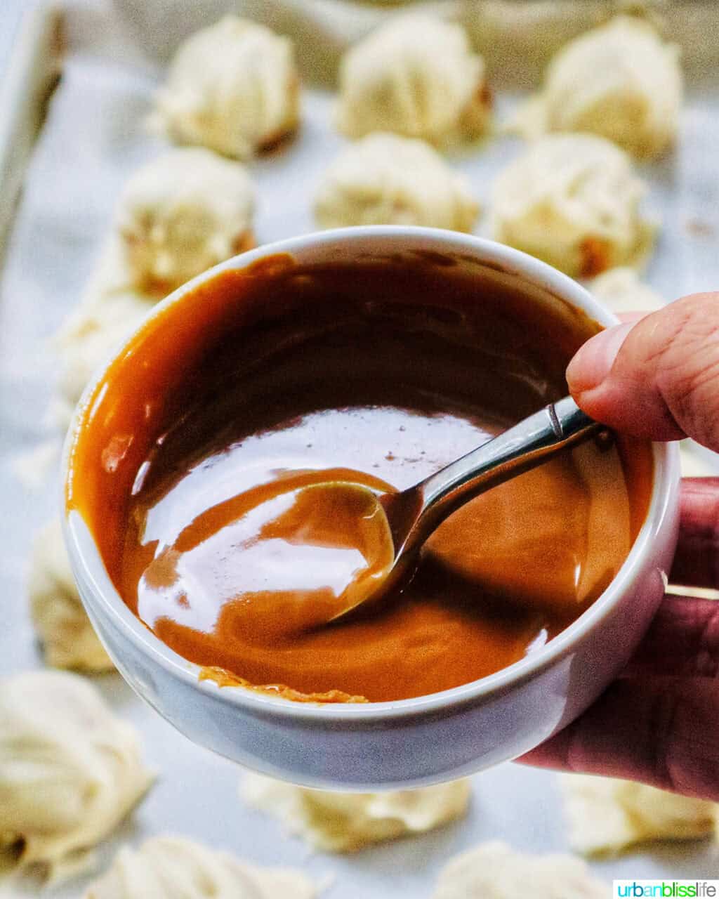 spoon dipped into melted Biscoff cookie spread.