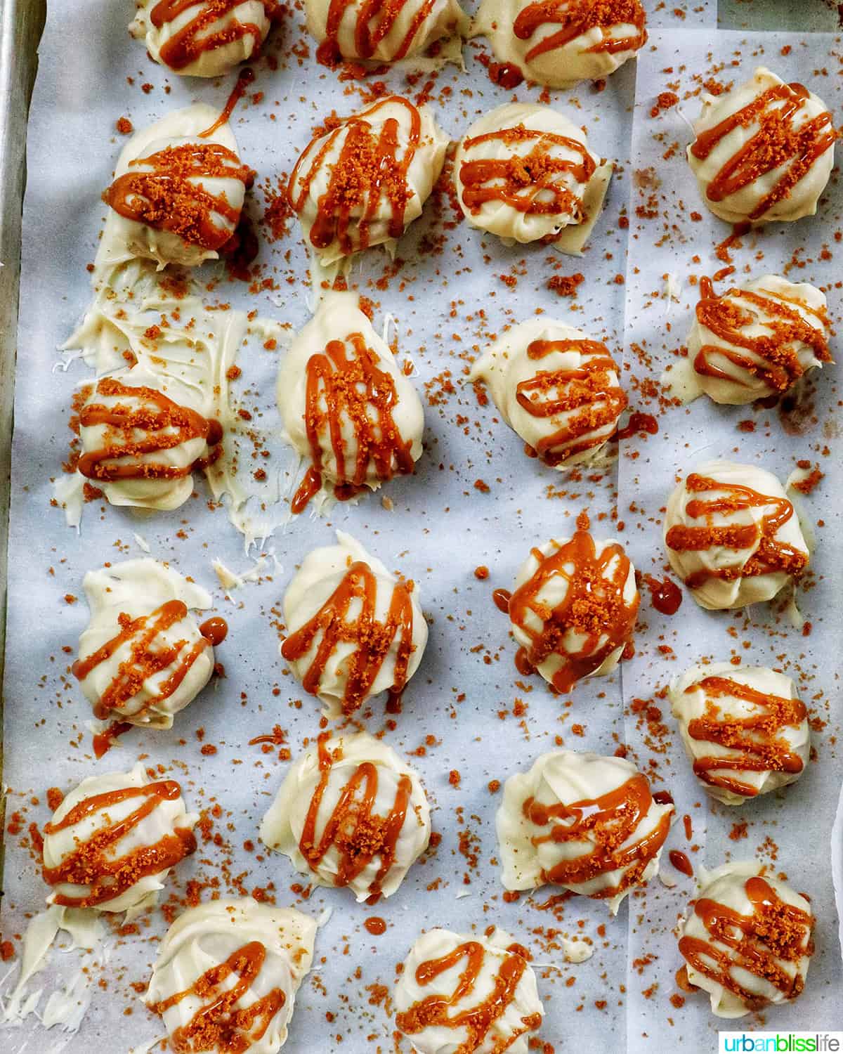rows of decorated Biscoff truffles on a baking sheet.