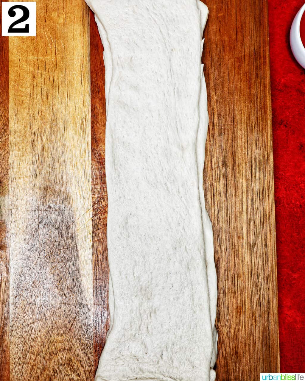 pizza dough on a cutting board.