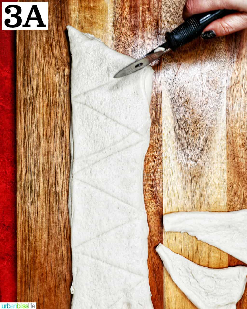 slicing triangles in refrigerated pizza dough.
