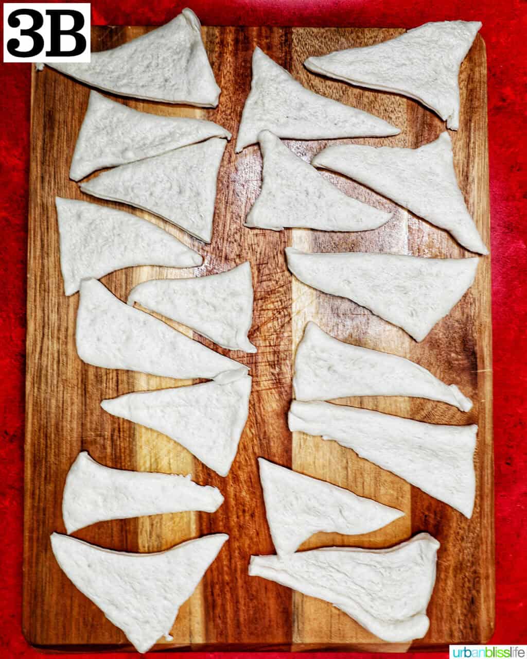 triangles of pizza dough on a cutting board.