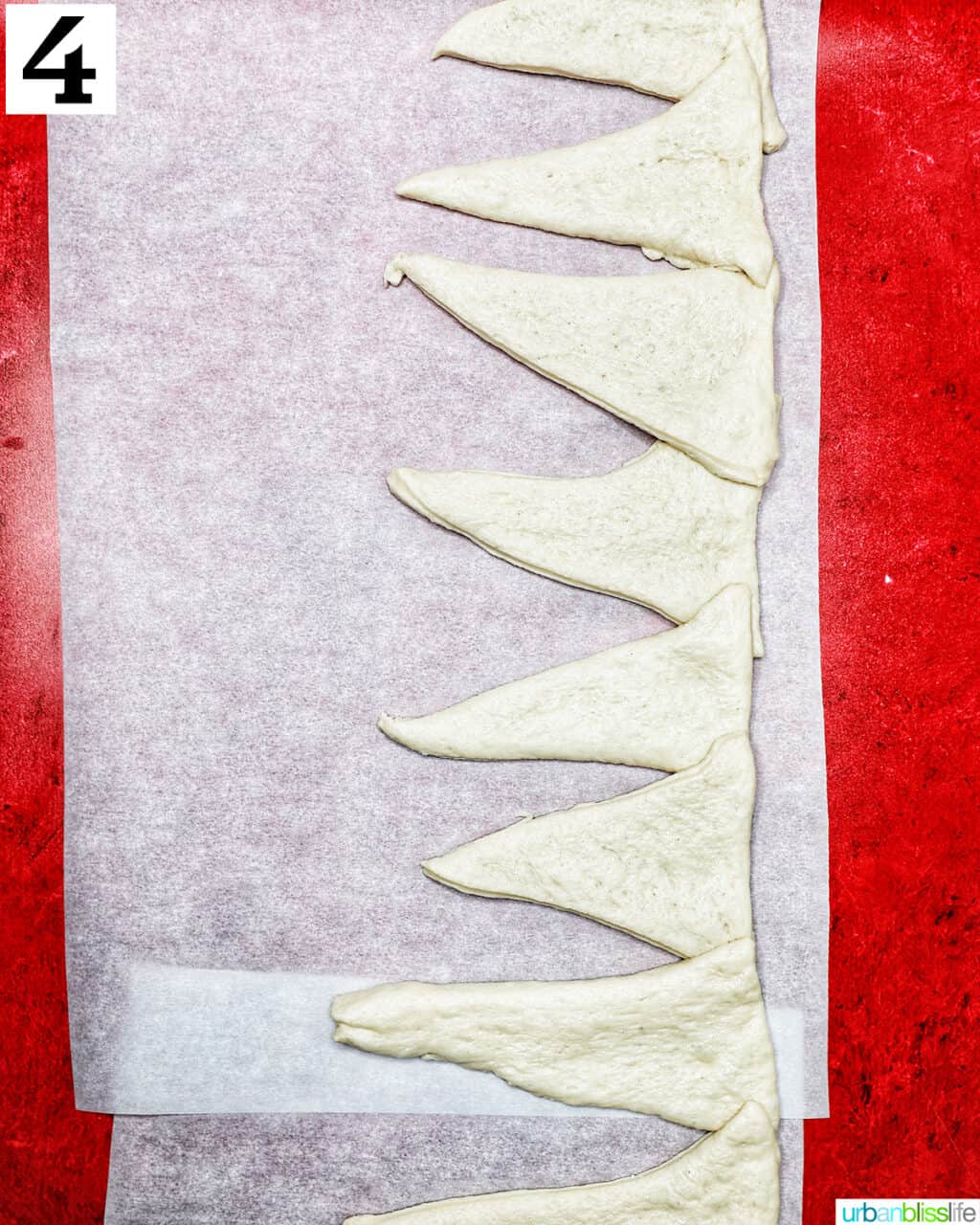 triangles of pizza dough pressed in a line together.