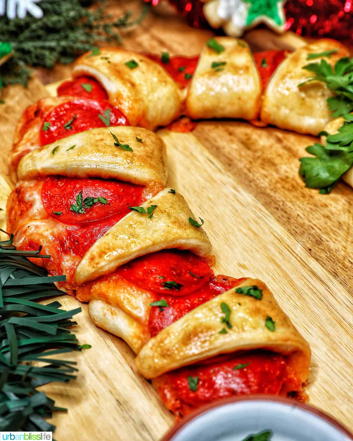 candy cane pizza surrounded by holiday decorations.