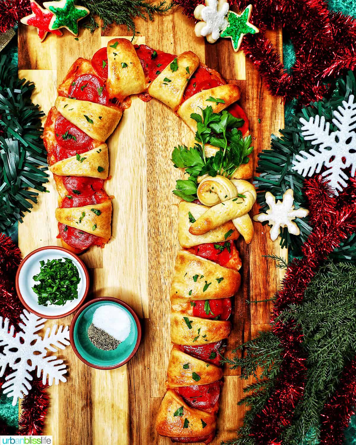 candy cane pizza surrounded by holiday decorations.